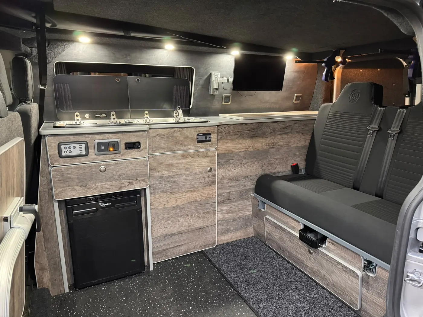 Finished StreetVanz campervan interior with fitted furniture, seating and lighting