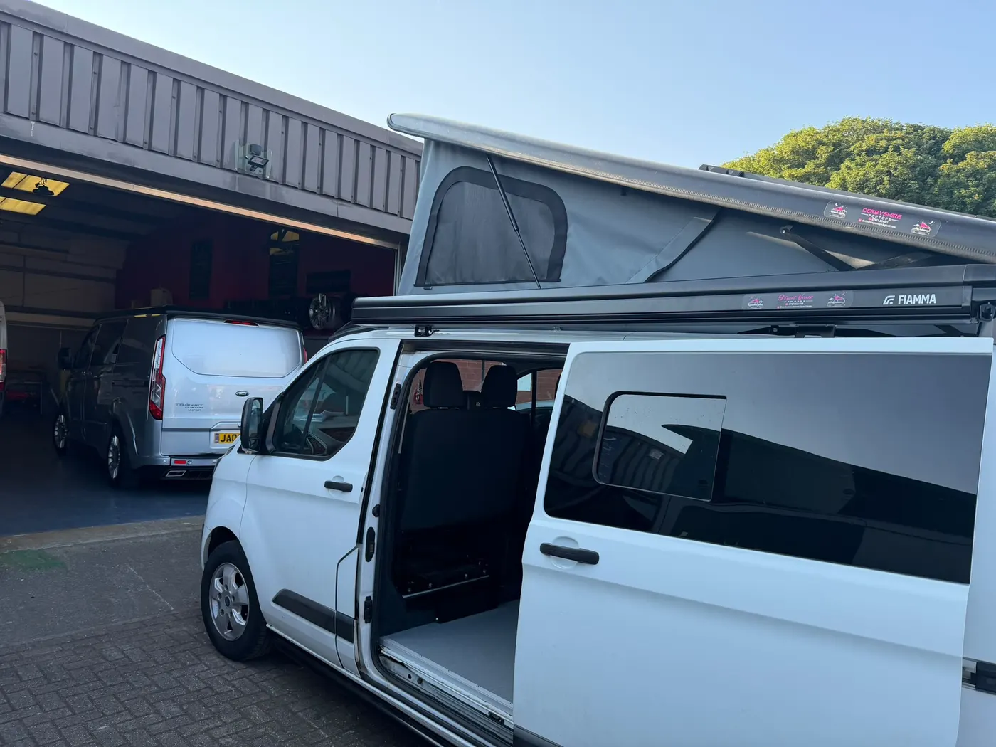 Completed campervan with an elevated pop-top roof